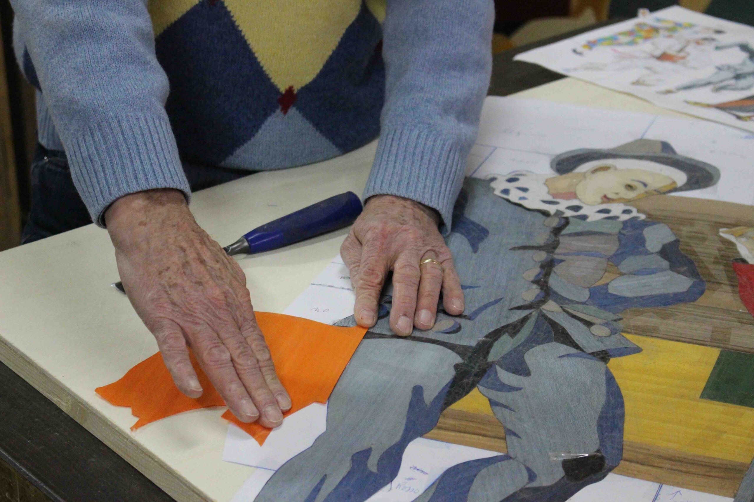 Pino Valenti combines the pieces of wood to create his artwork